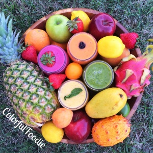 Smoothies surrounded by tropical fruit
